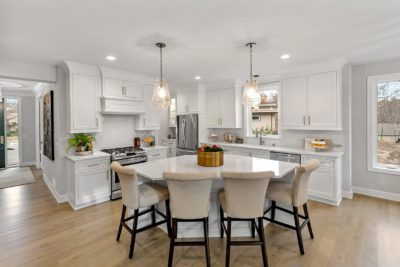 Luxury kitchen with custom finishes, white cabinetry, and a center island